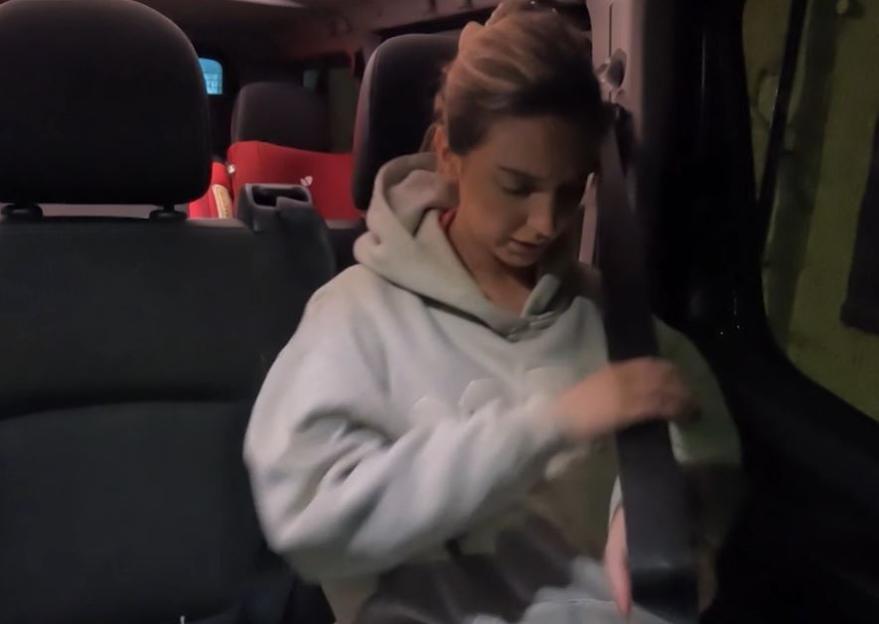 Pregnant Chloe Radford fastening her seatbelt in a car.
