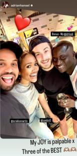Photo of four people smiling together.