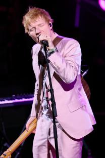 Ed Sheeran performing onstage.
