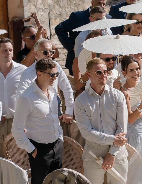 Wedding guests at an outdoor ceremony.