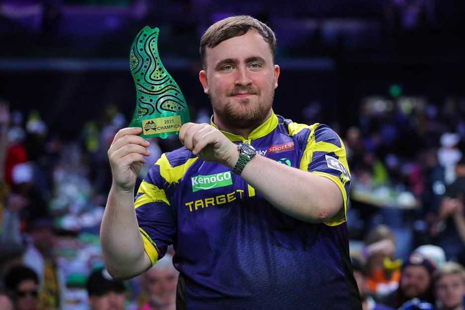 Luke Littler holding the Australian Darts Masters trophy.