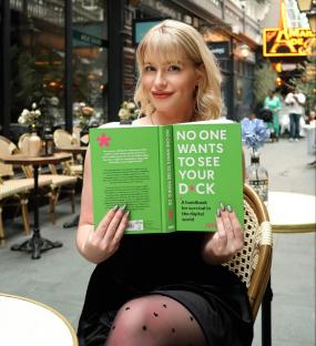 Jess Davies holding her book,