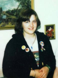 Photo of a young girl wearing a black cardigan with buttons.