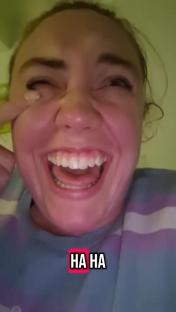 Close-up of a woman laughing.