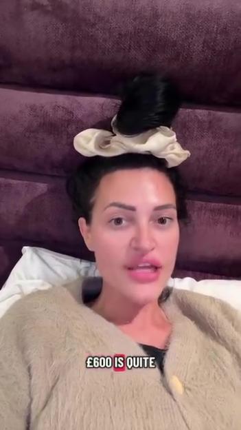 A woman with dark hair in a bun with a scrunchie is shown in a close-up, wearing a fuzzy sweater with text overlaid that reads "£600 is quite".