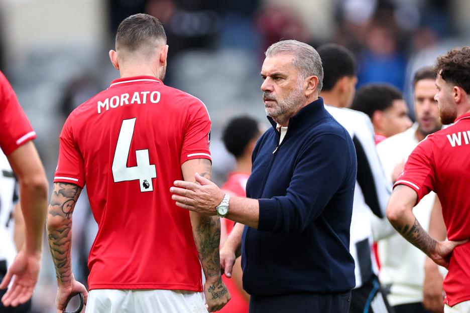 Disheartened Ange Postecoglou, head coach of Nottingham Forest, converses with Morato of Nottingham Forest.