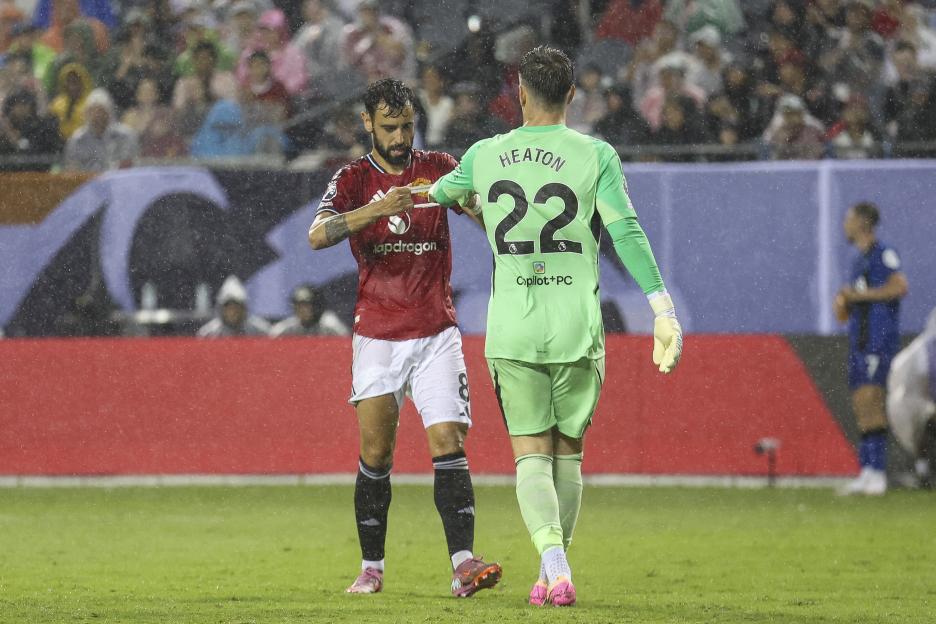Bruno Fernandes handing the captain's armband to Tom Heaton.
