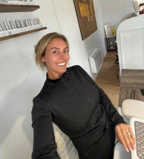 Woman smiling in her beauty salon.