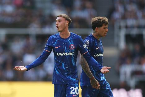 Two Chelsea F.C. soccer players react during a match.