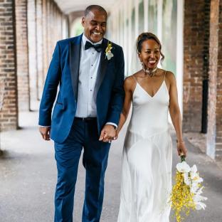 Mark Bright and his wife walking hand-in-hand after their wedding.
