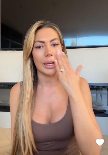 Woman wiping a tear from her face.