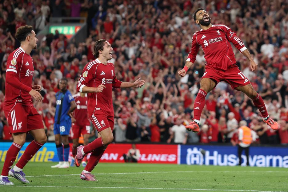 Mohamed Salah of Liverpool celebrating a goal with teammates.