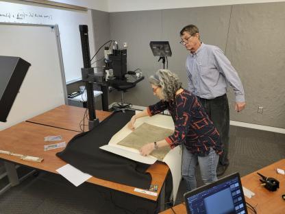 Researchers using imaging technology on a copy of the Magna Carta.