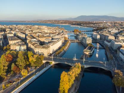 Aerial view of the Rhone river flowing through Geneva's business district.