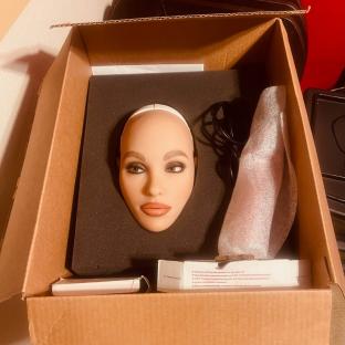 A sex doll head in a box.