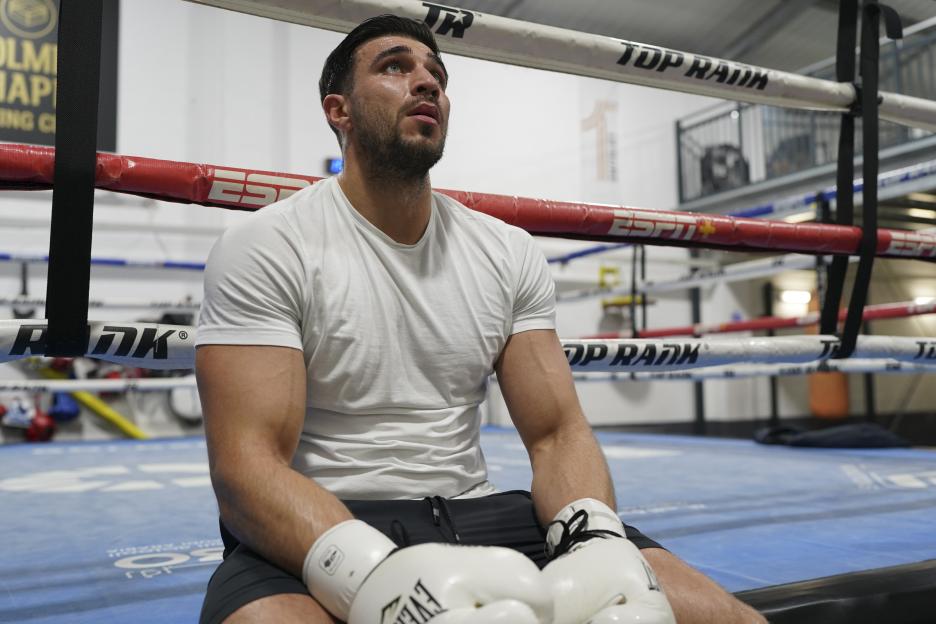 Close-up of Tommy Fury sitting in a boxing ring.