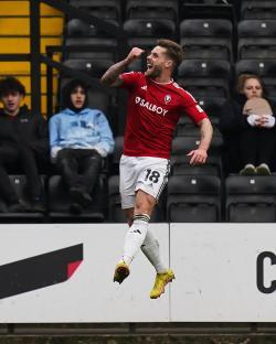 Conor McAleny of Salford City celebrates scoring a goal.