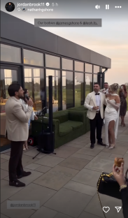 Screenshot of a wedding reception, a man singing into a microphone.