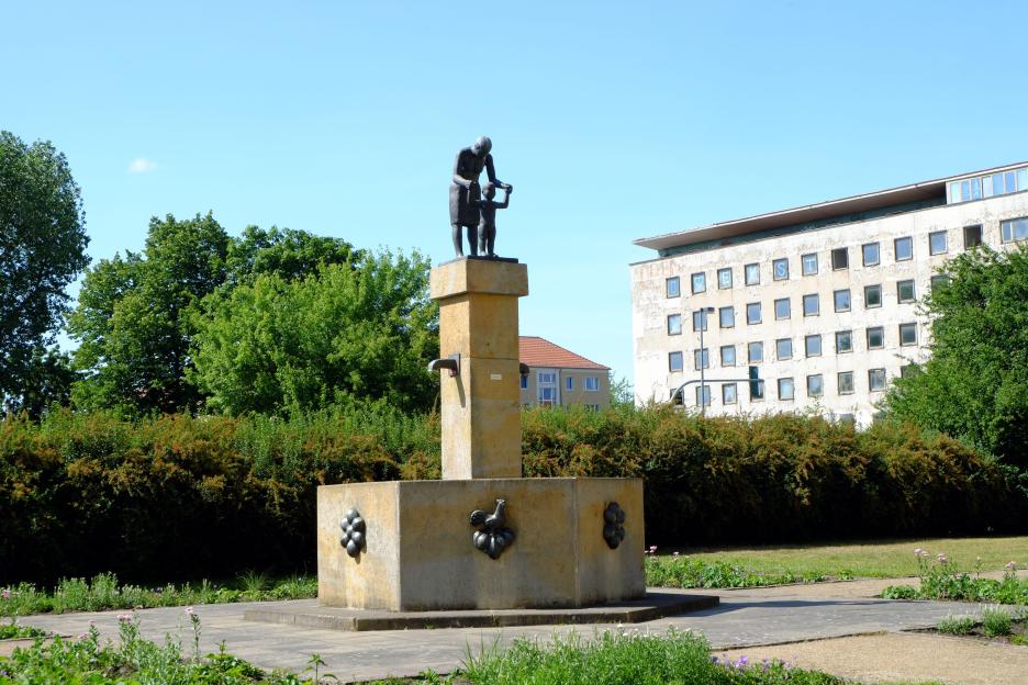 Sculpture of a mother and child on a fountain.