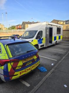 Police car and van at a crime scene.