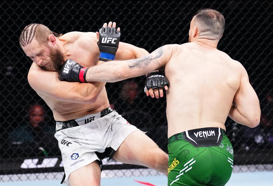 Modestas Bukauskas punches Marcin Prachnio in a UFC fight.