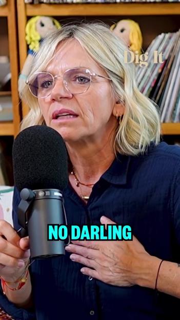 Woman speaking into a microphone; "Dig It" and "No Darling" superimposed on the image.