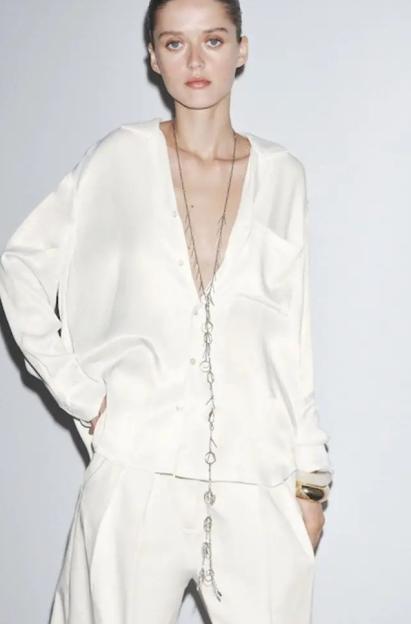 Zara advert featuring a model in a white shirt and trousers.