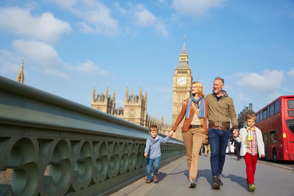 Family walking across Westminster Bridge in London.
