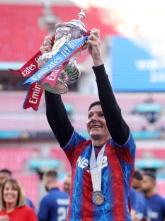 Crystal Palace manager holding up a trophy.