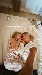 Molly Mae Hague and Tommy Fury's daughter cuddling in bed.