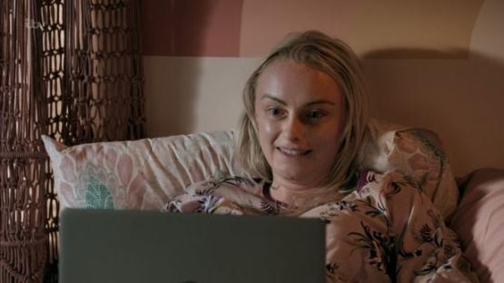 Sinead Tinker in bed using a laptop.
