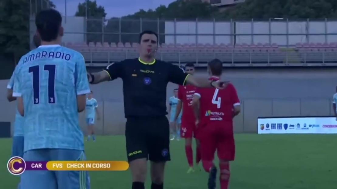 Soccer referee showing a card to a player.