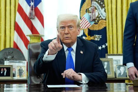 President Trump in the Oval Office, pointing.