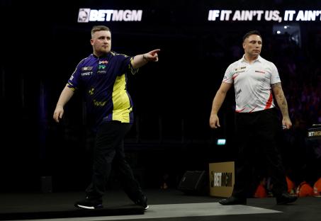 Luke Littler reacting during a darts semifinal match.