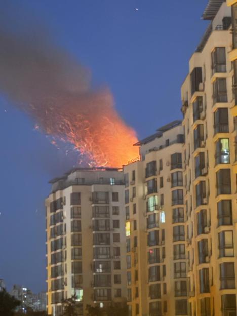 Apartment building on fire at night.