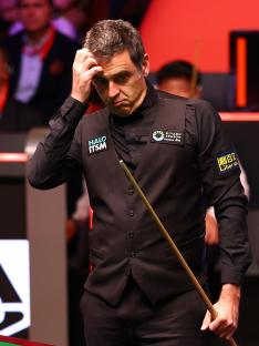 Ronnie O'Sullivan reacting during a snooker match.