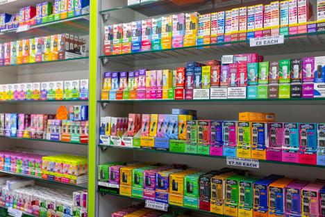 Shop shelves stocked with disposable vapes, the sale of which is soon to be illegal.