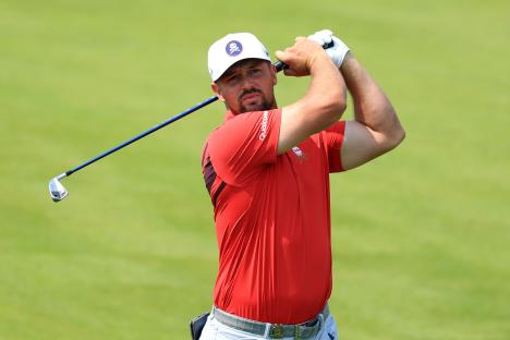 Bryson DeChambeau taking a golf swing.