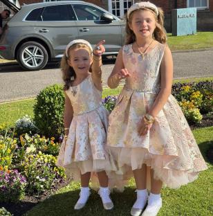 Two girls in floral dresses.