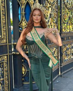 Miss Grand United Kingdom 2023 in a green gown and crown.