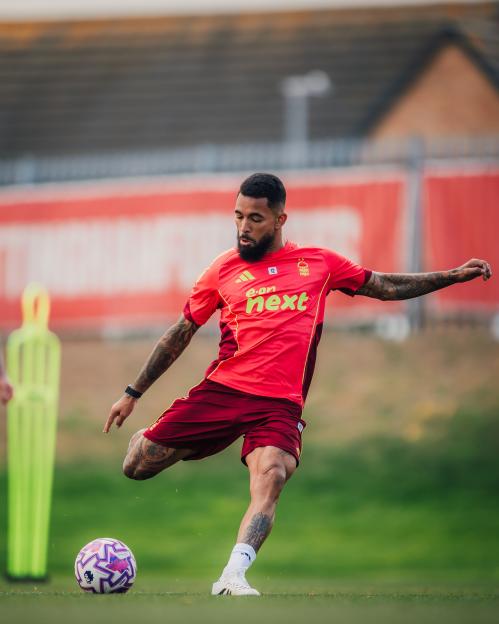 Douglas Luiz of Nottingham Forest kicking a soccer ball during training.