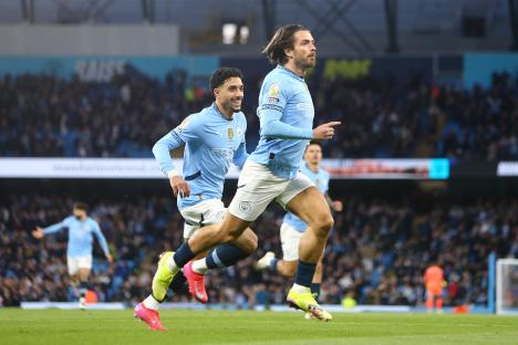 Manchester City players celebrating a goal.