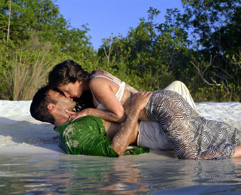 Sexy couple kissing on seashore