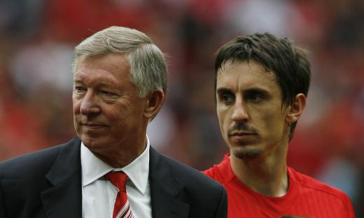 Sir Alex Ferguson and Gary Neville at a Manchester United game.