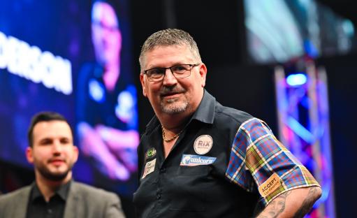 Gary Anderson smiling after winning a darts match.