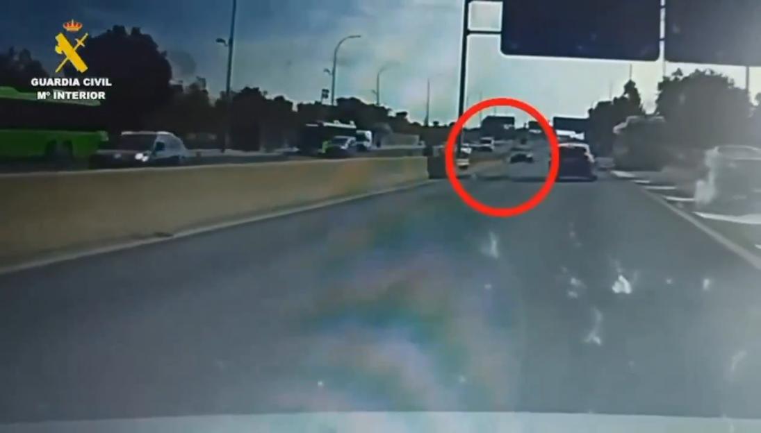 Dashcam footage of a car driving the wrong way on a motorway, causing an accident.