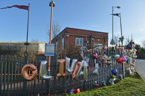 Floral tributes and balloons spelling