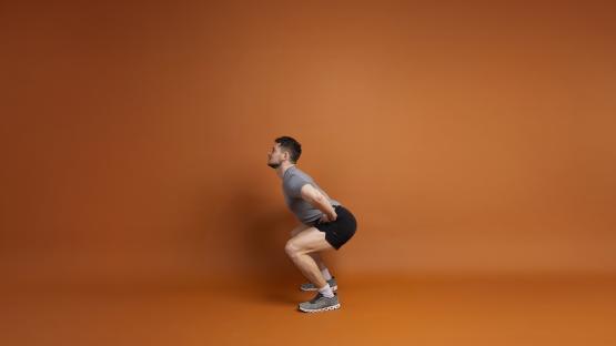 Man performing a squat.