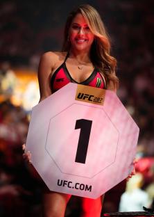 UFC Octagon Girl Brittney Palmer holding a round 1 sign.