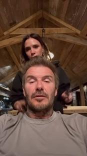 Victoria Beckham giving David Beckham a massage.